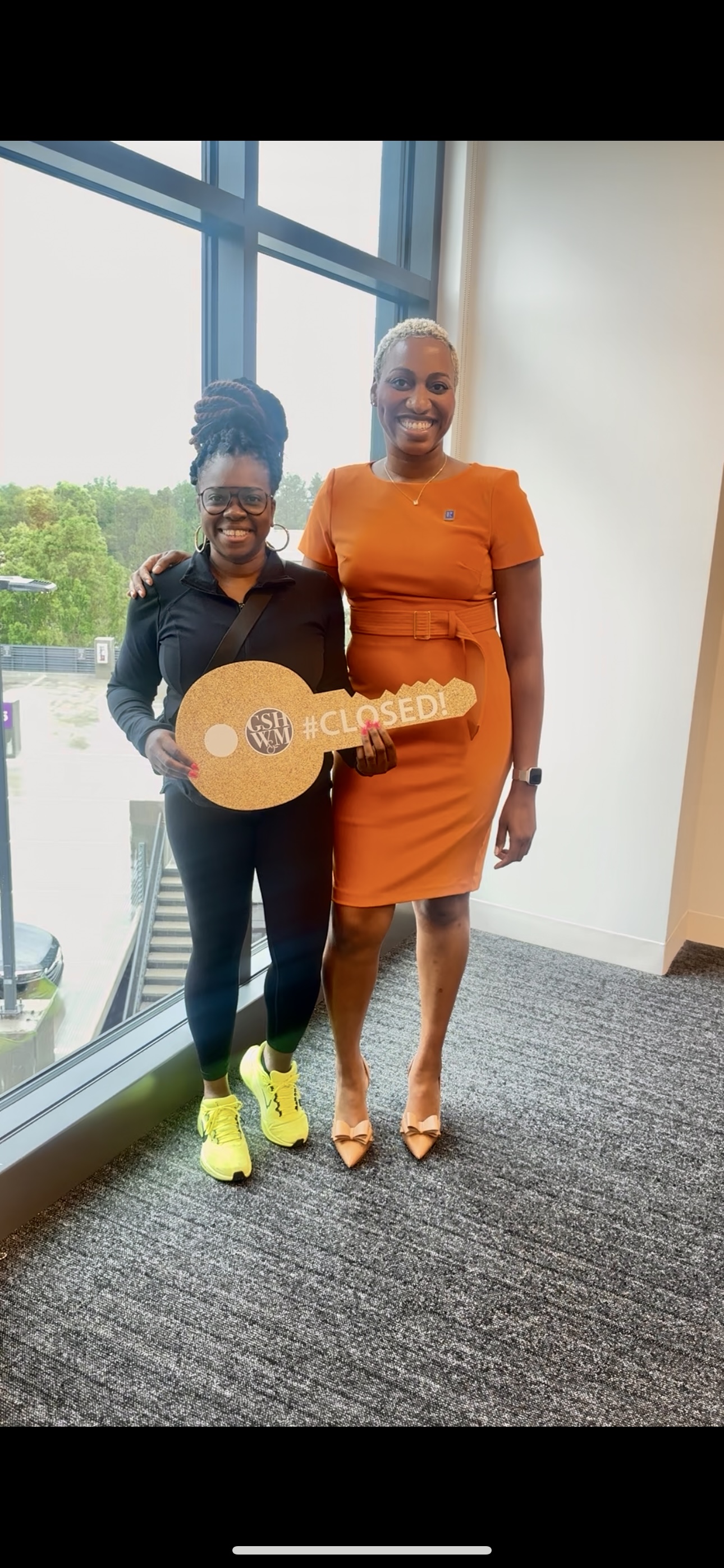 Jacqueline Walker with a recent client at closing — guided through a major life transition.