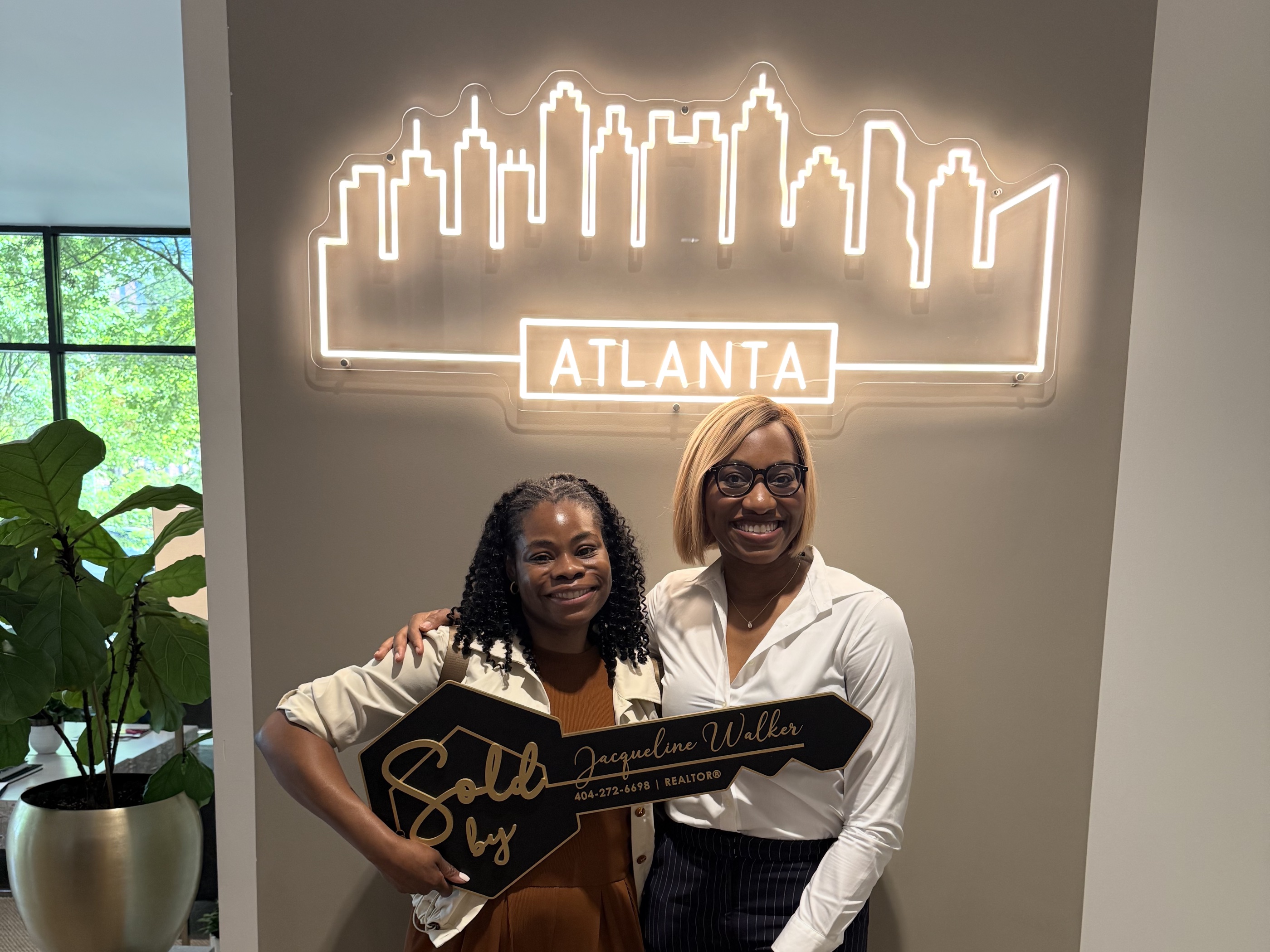 Jacqueline Walker with her client at closing — the sale of 1328 Weatherstone Way NE.